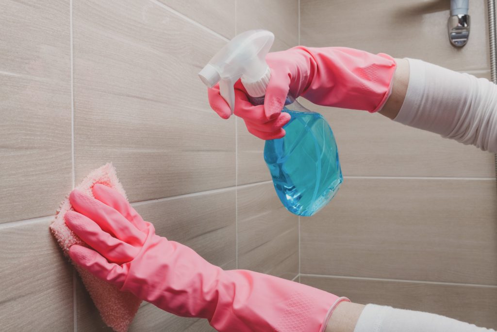 hands-in-rubber-gloves-cleaning-tiles