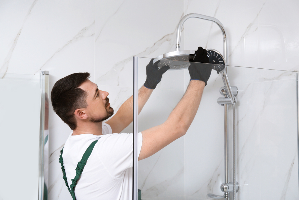 expert installing a new shower in a bathroom